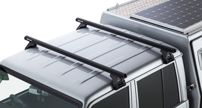 Kit 2 barres de toit noire Heavy Duty 1500mm avec pieds RL110 Toyota Land Cruiser série 79 2007+ - RHINO-RACK - Toyota Land Cruiser 78/79